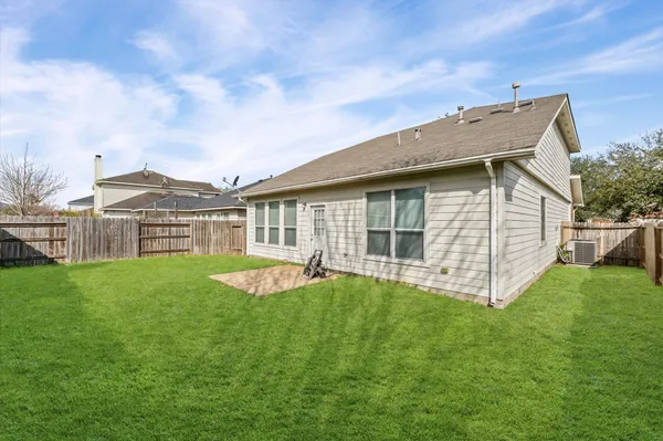 a view of a house with a yard and deck