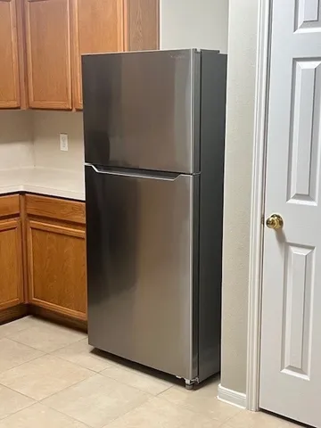 a view of a kitchen with a refrigerator and an oven