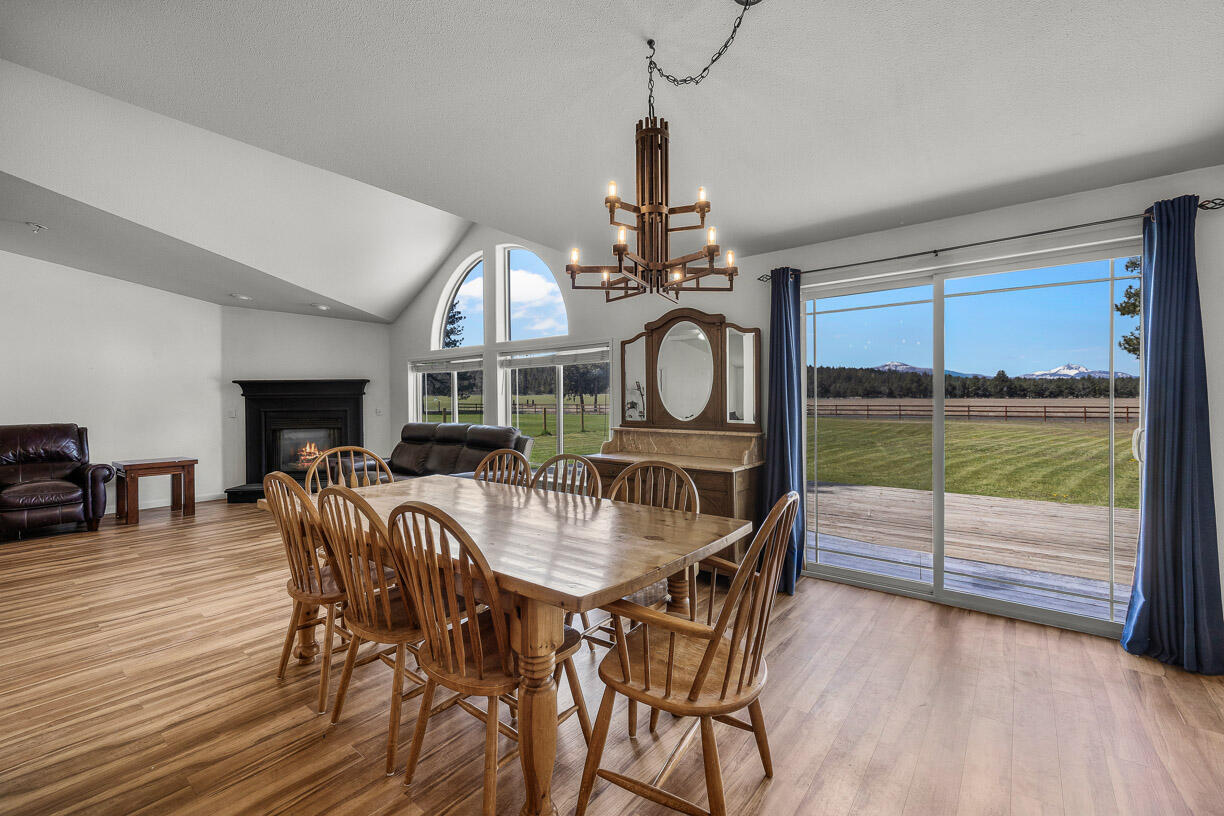67500 Harrington Loop Road Bend, OR 97703 - Photo 11 of 72 a view of a dining room with furniture window and wooden floor