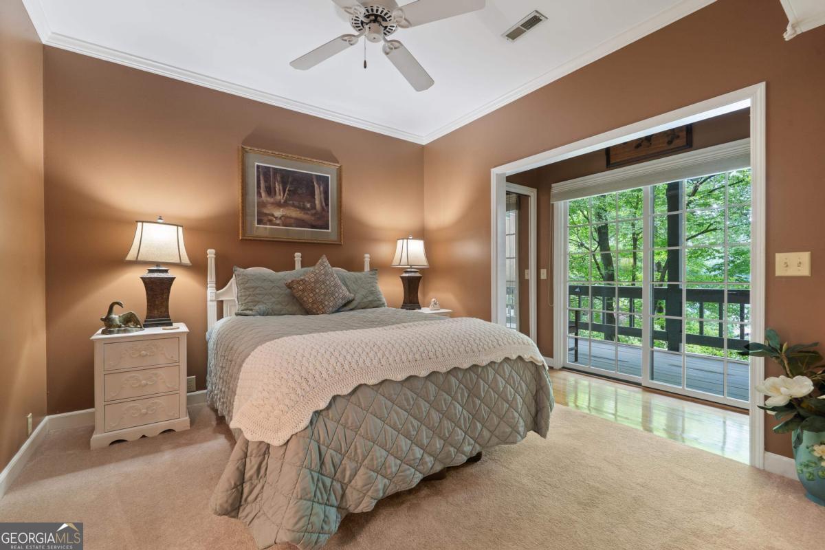 1031 Old Still Road Greensboro, GA 30642 - Photo 57 of 73 a spacious bedroom with a bed and large window