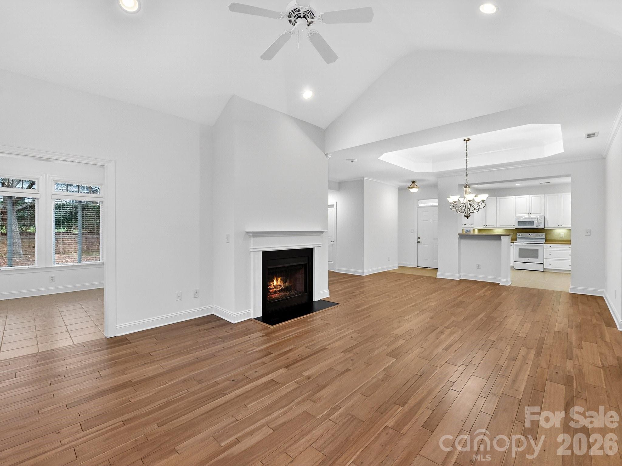2963 Bellasera Way Matthews, NC 28105 - Photo 12 of 45 a view of empty room with wooden floor and fireplace