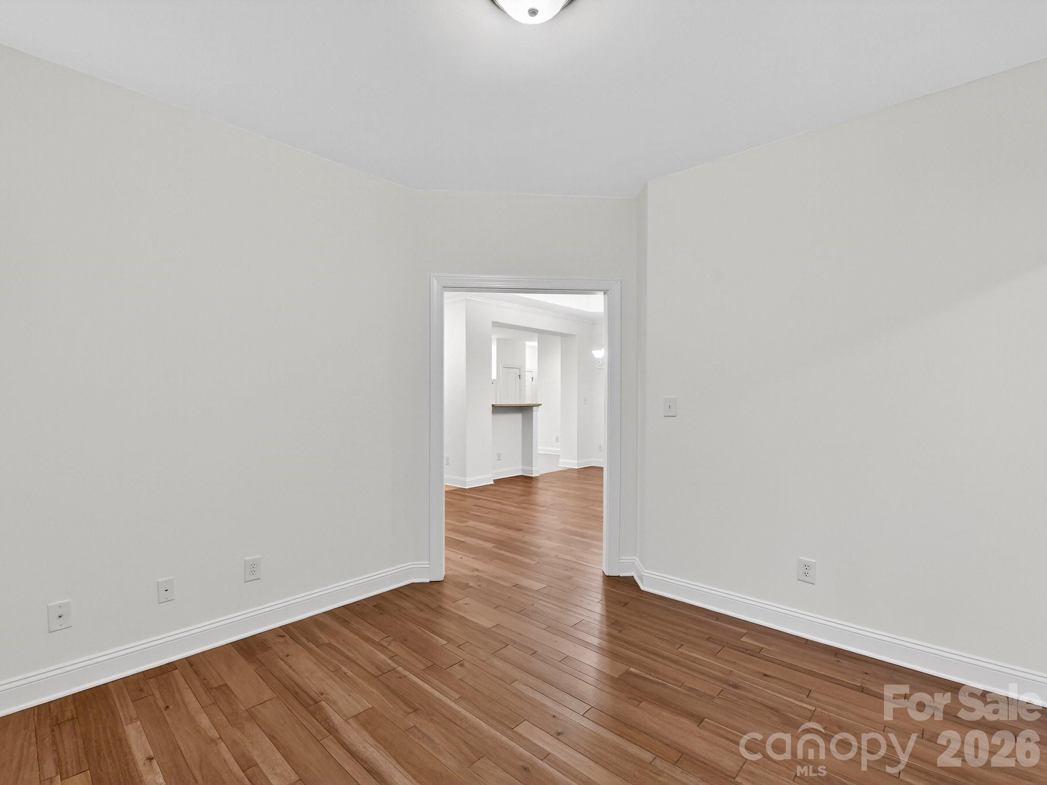 2963 Bellasera Way Matthews, NC 28105 - Photo 21 of 45 a view of an empty room and wooden floor and a window