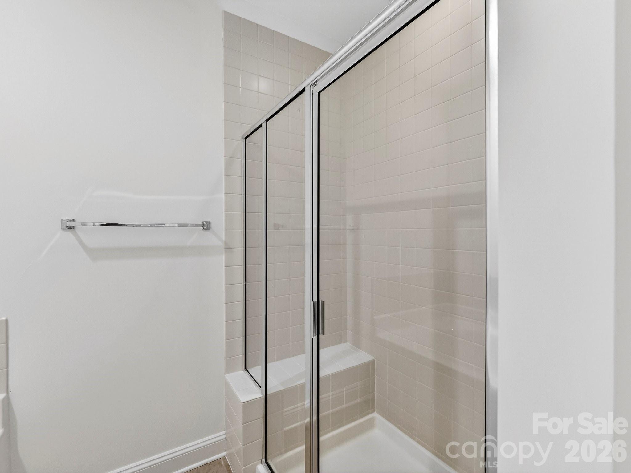 2963 Bellasera Way Matthews, NC 28105 - Photo 27 of 45 a bathroom with a glass shower door