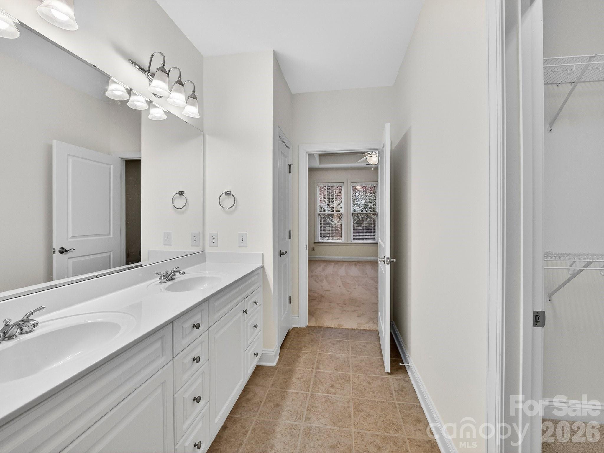 2963 Bellasera Way Matthews, NC 28105 - Photo 28 of 45 a spacious bathroom with a granite countertop sink a mirror and a shower