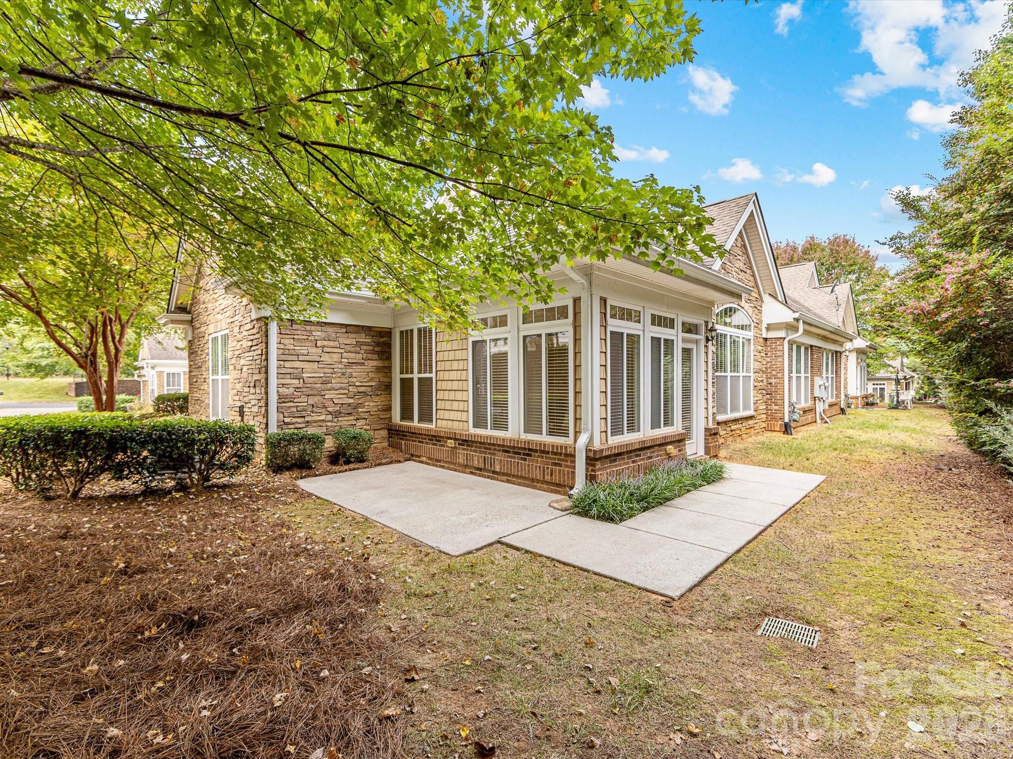2963 Bellasera Way Matthews, NC 28105 - Photo 36 of 45 a view of a house with a yard and large tree