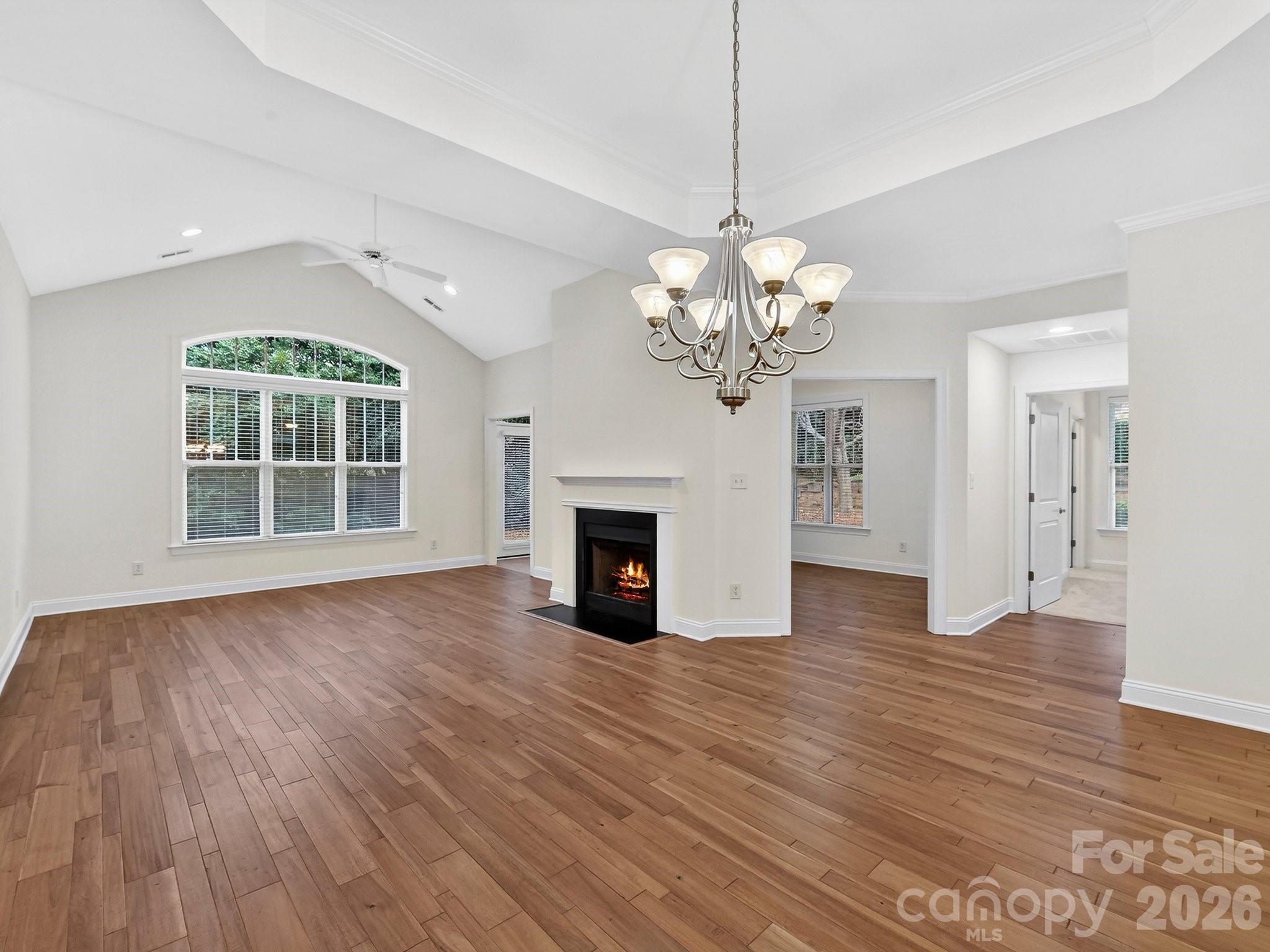 2963 Bellasera Way Matthews, NC 28105 - Photo 9 of 45 a view of a room with wooden floors and fireplace