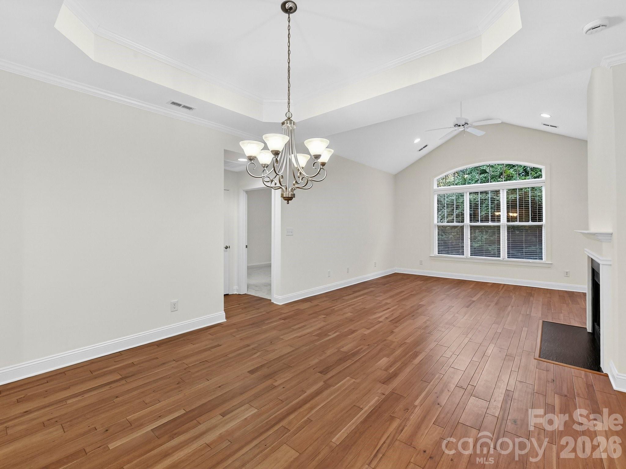 2963 Bellasera Way Matthews, NC 28105 - Photo 10 of 45 a view of a room with wooden floor and chandelier
