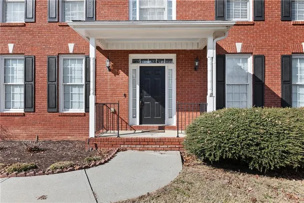 front view of a brick house with a large windows