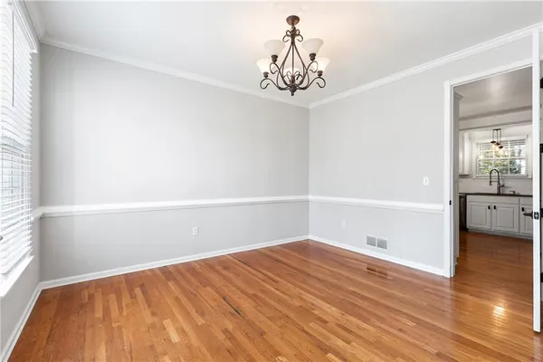 a view of a room with wooden floor and a window