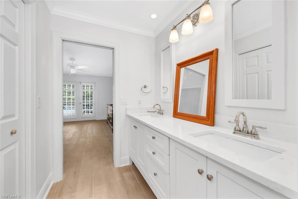 4711 Crayton Road Naples, FL 34103 - Photo 12 of 14 a bathroom with a sink a mirror and a window
