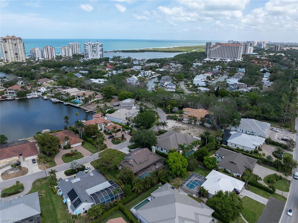 4711 Crayton Road Naples, FL 34103 - Photo 7 of 14 an aerial view of a city with lots of residential buildings ocean and mountain view in back