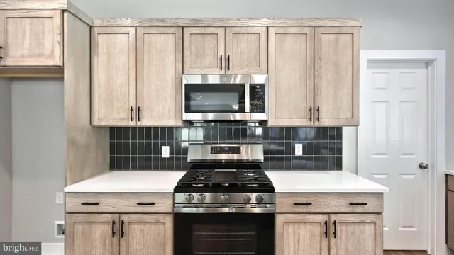 a kitchen with a stove and a microwave