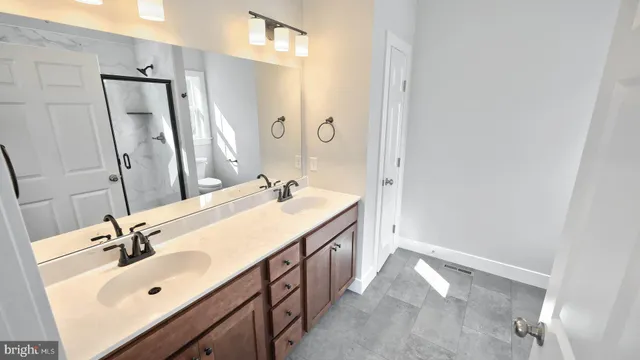 a bathroom with a double vanity sink mirror and double