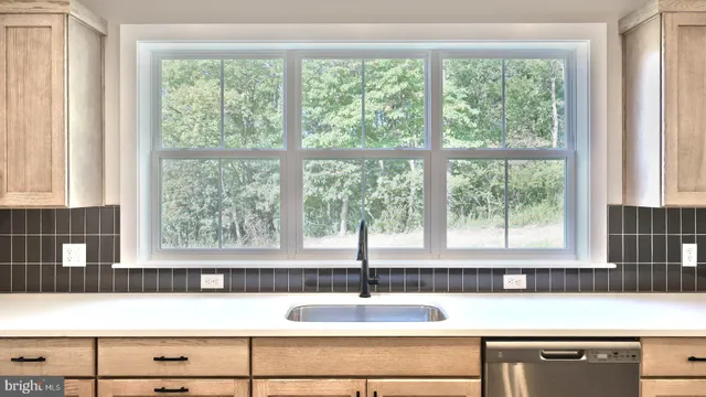 a view of a sink and a large window