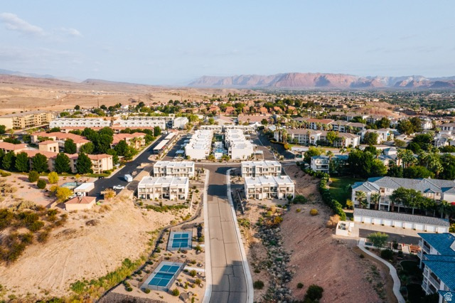1122 South 1790th West, Unit 1 St. George, UT 84770 - Photo 37 of 37 Aerial perspective featuring a residential community with multi-story buildings and red rock formations in the distance