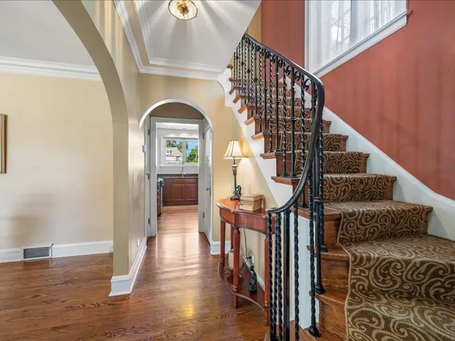 a view of entryway with wooden floor and a front door