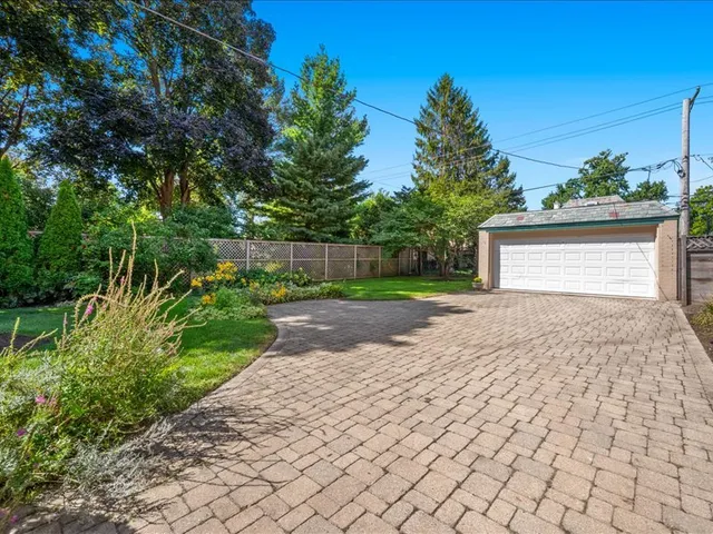 a front view of a house with a yard and a garage
