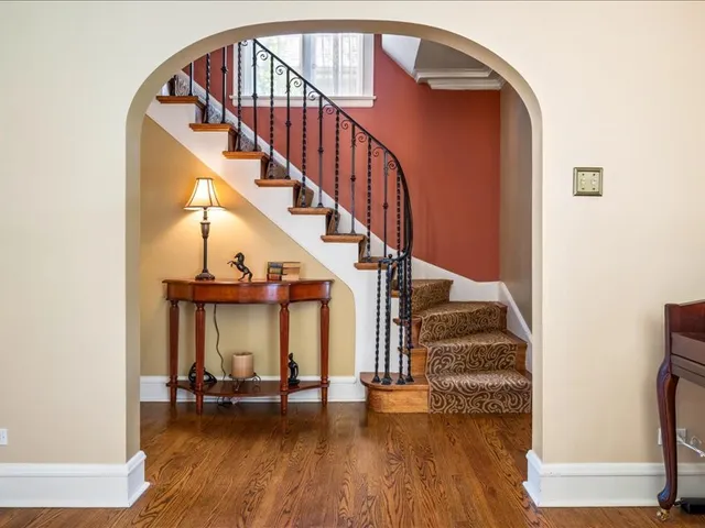 a view of entryway and hall with wooden floor
