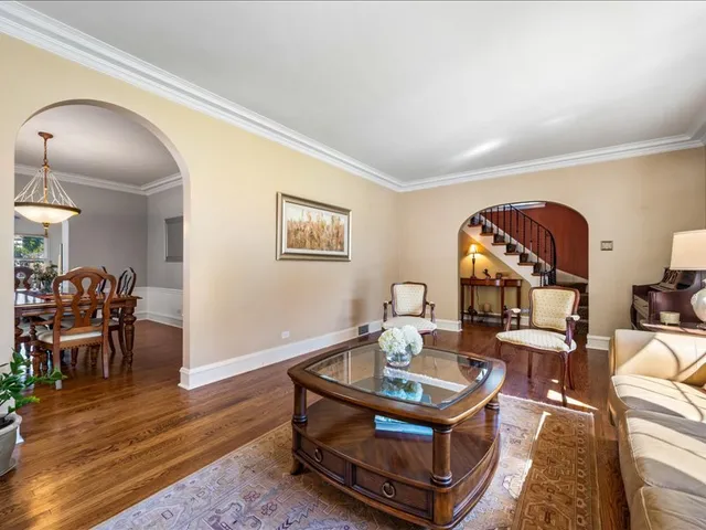 a living room with furniture a rug and a table