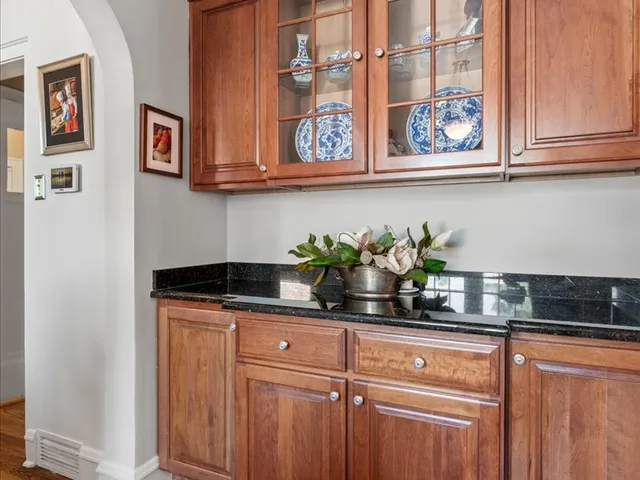 a kitchen with stainless steel appliances granite countertop a sink a stove and cabinets