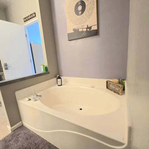 a bathroom with a tub and a sink