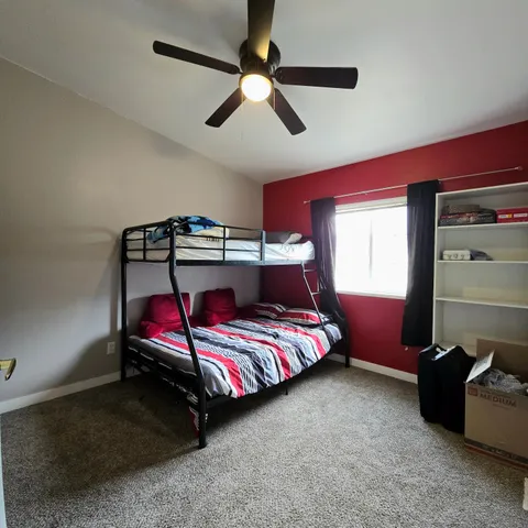 a bedroom with bed and window