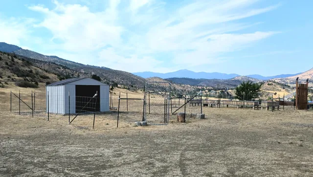 a view of a barn in the middle of a yard