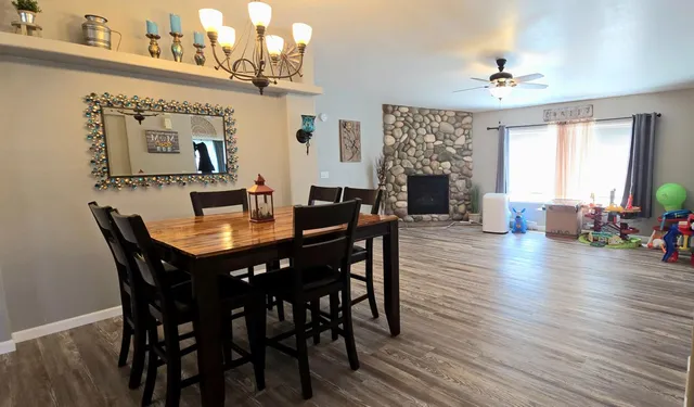 a view of a a dining room with furniture window and wooden floor