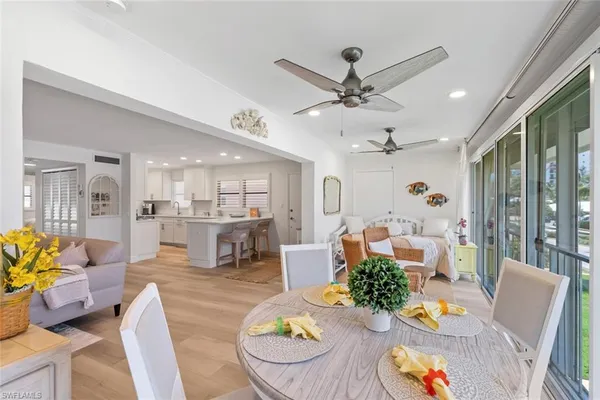 a living room with furniture kitchen and a chandelier