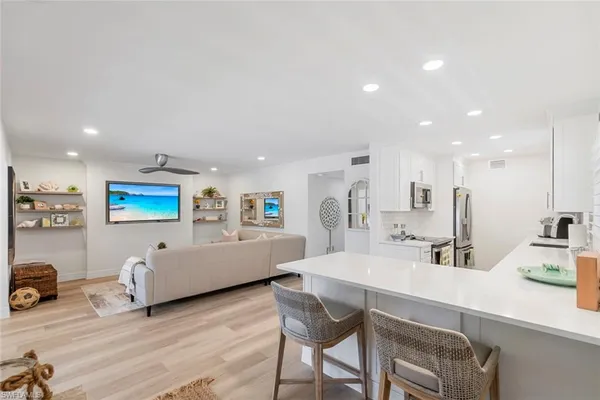 a living room with furniture and wall paintings