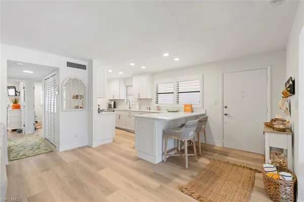 a kitchen with a sink appliances and cabinets