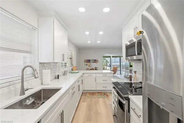 a kitchen with a sink stove and cabinets
