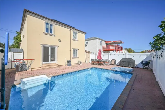 a view of a house with swimming pool and sitting area