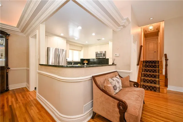 a kitchen with stainless steel appliances granite countertop a refrigerator and a stove top oven