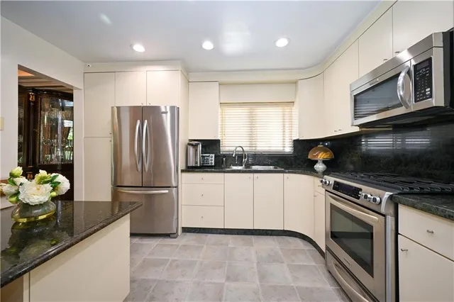 a kitchen with a refrigerator stove and microwave