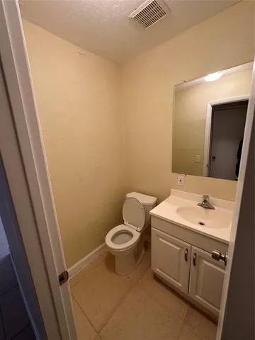a bathroom with a sink toilet and vanity