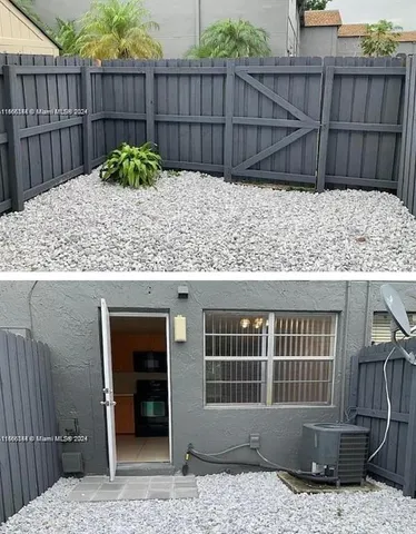 a view of a house with a tub and wooden fence