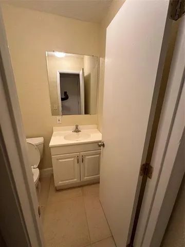 a bathroom with a sink a toilet and mirror