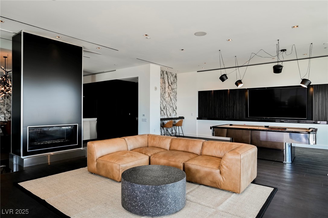 4381 West Flamingo Road, Unit 5708 Las Vegas, NV 89103 - Photo 25 of 34 Living area featuring a fireplace and new flooring