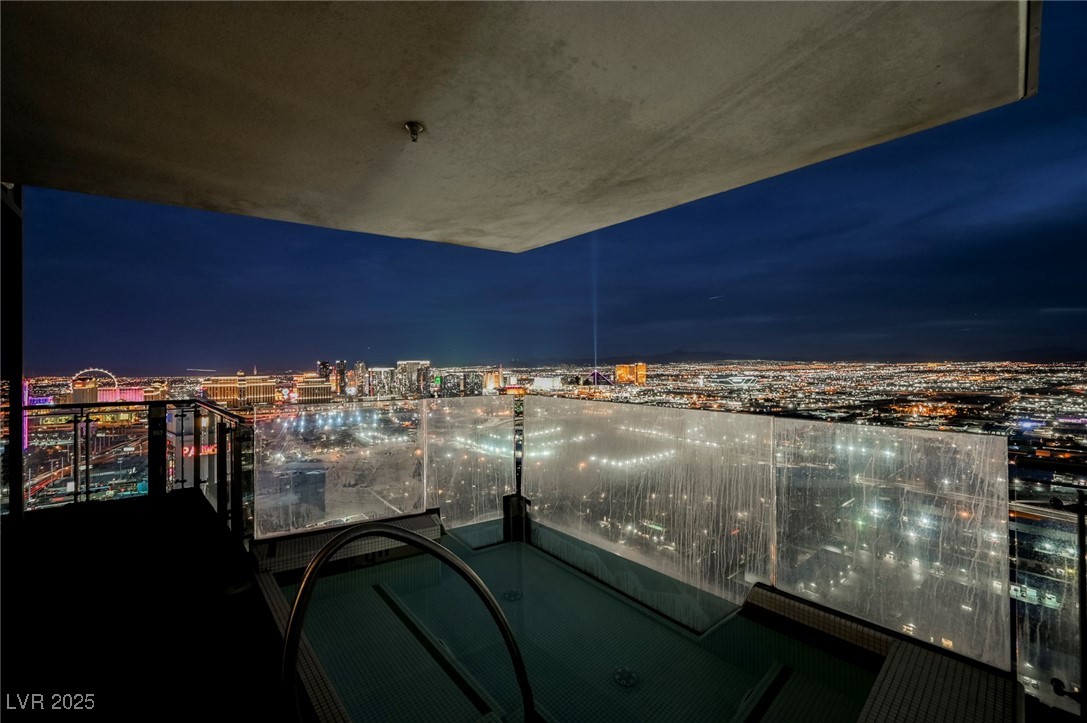 4381 West Flamingo Road, Unit 5708 Las Vegas, NV 89103 - Photo 4 of 34 Bedroom with access to outside, dark wood-type flooring, wood ceiling, and a city view