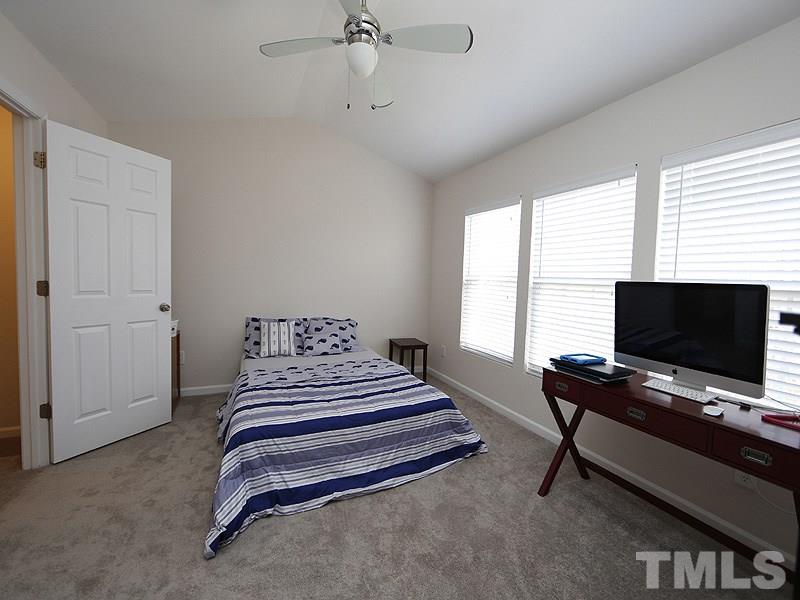 8210 Clasara Circle Raleigh, NC 27613 - Photo 11 of 14 a bedroom with a bed and a flat screen tv