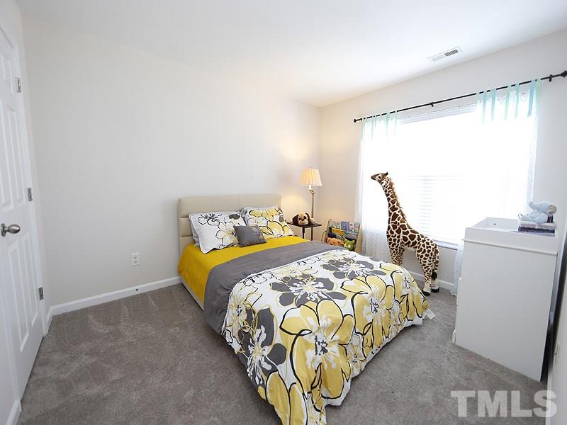 8210 Clasara Circle Raleigh, NC 27613 - Photo 13 of 14 a bedroom with a bed and a window