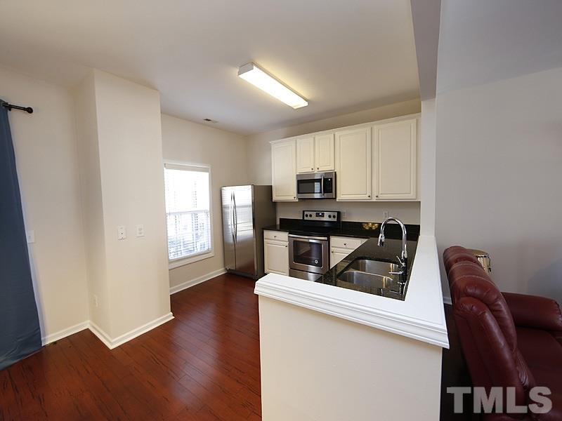 8210 Clasara Circle Raleigh, NC 27613 - Photo 4 of 14 a kitchen with a refrigerator stove top oven and sink