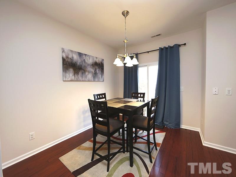 8210 Clasara Circle Raleigh, NC 27613 - Photo 6 of 14 a view of a dining room with furniture window and wooden floor