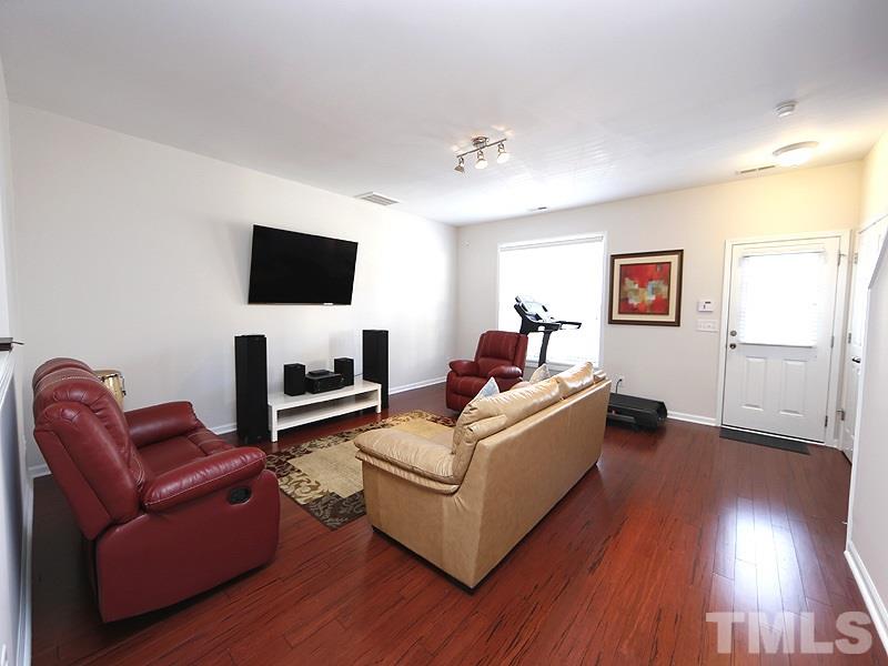 8210 Clasara Circle Raleigh, NC 27613 - Photo 7 of 14 a living room with furniture and a flat screen tv