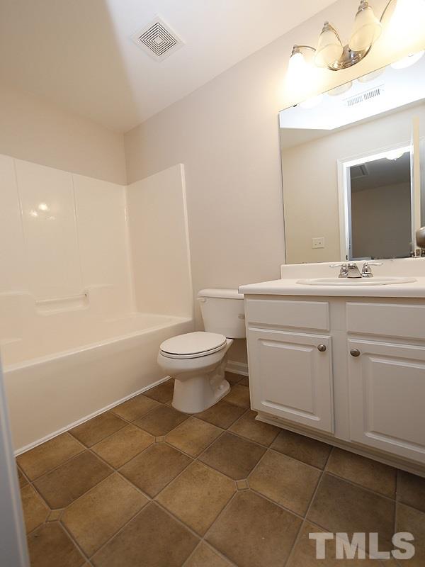 8210 Clasara Circle Raleigh, NC 27613 - Photo 9 of 14 a bathroom with a sink toilet and shower