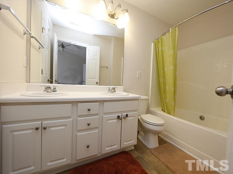 8210 Clasara Circle Raleigh, NC 27613 - Photo 10 of 14 a bathroom with a double vanity sink toilet and shower