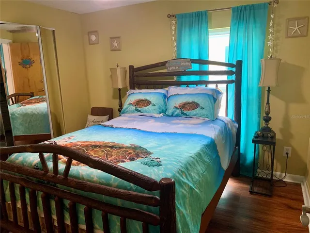 a bedroom with a bed and a mirror