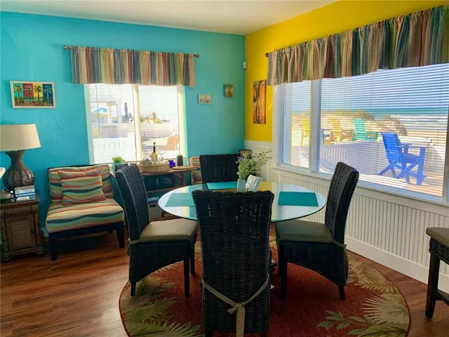 a living room with furniture a window and a flat screen tv