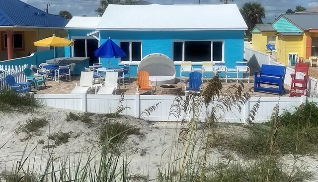 a living room with furniture and a baby crib
